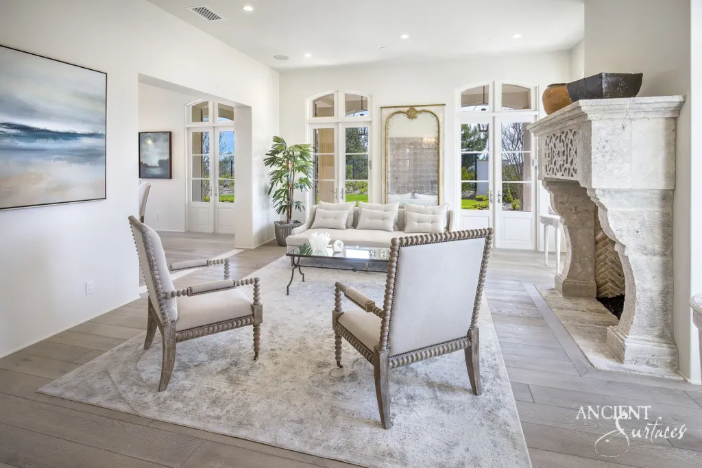 Villa living room mantel cut from limestone with a pierced fretwork frieze and heavy scrolled legs